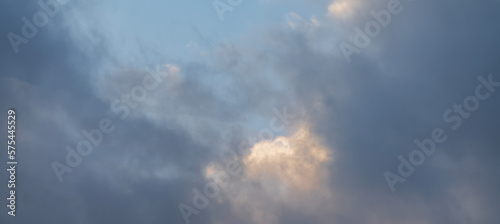 Beautiful orange clouds on the blue sunset sky. Sky clouds background.