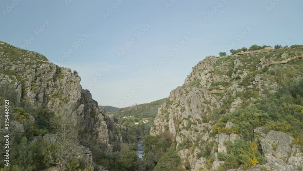 Drone view of the river Ceira passing in between two rocky mountains in Portugal. Cabril do Ceira, Fragas do Cabril