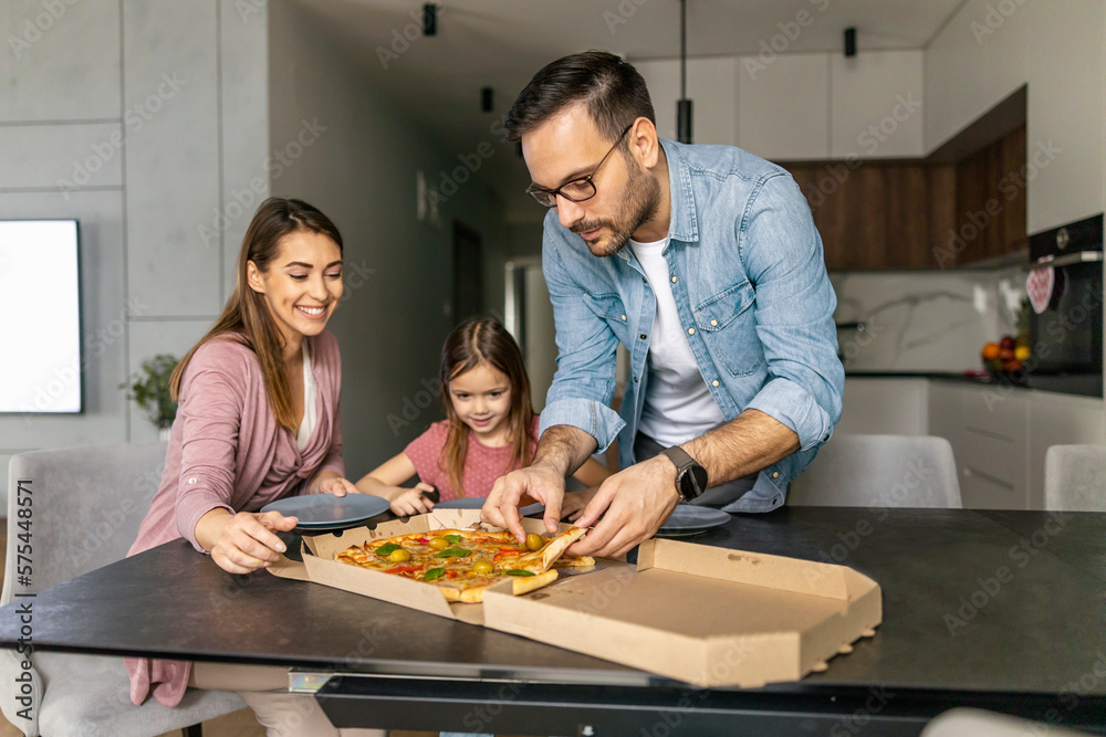 Happy family eating pizza at home Happy family eating pizza at home