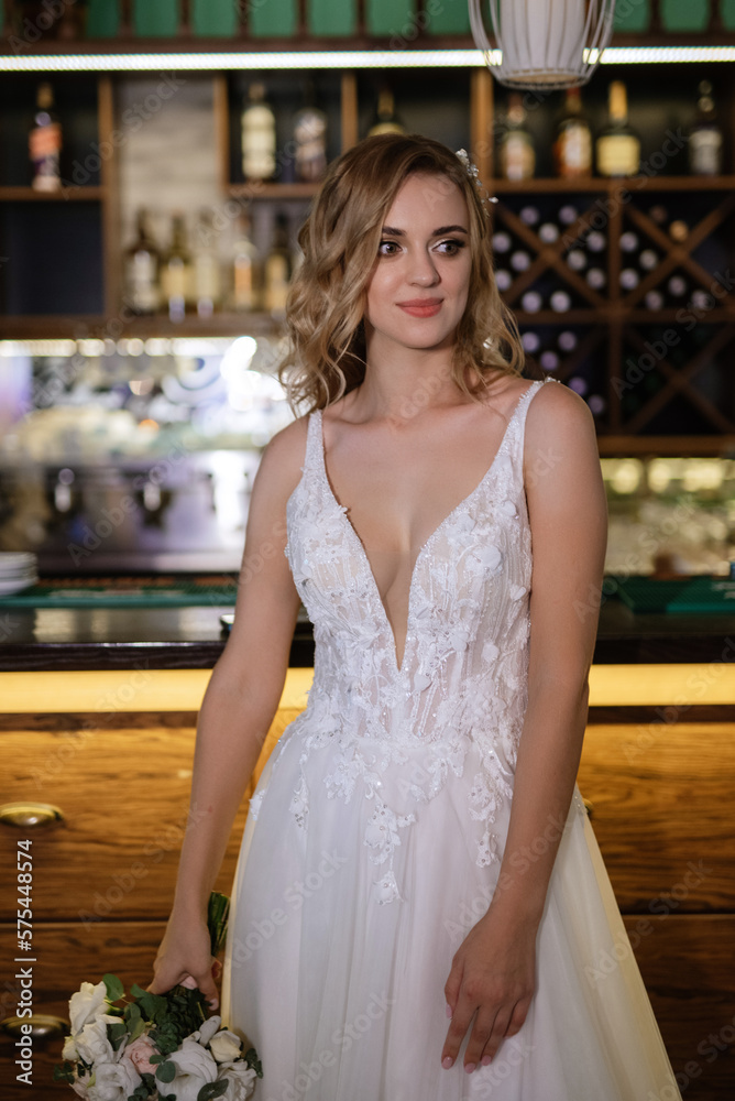 Naklejka premium blonde bride in a bar near with a wedding bouquet