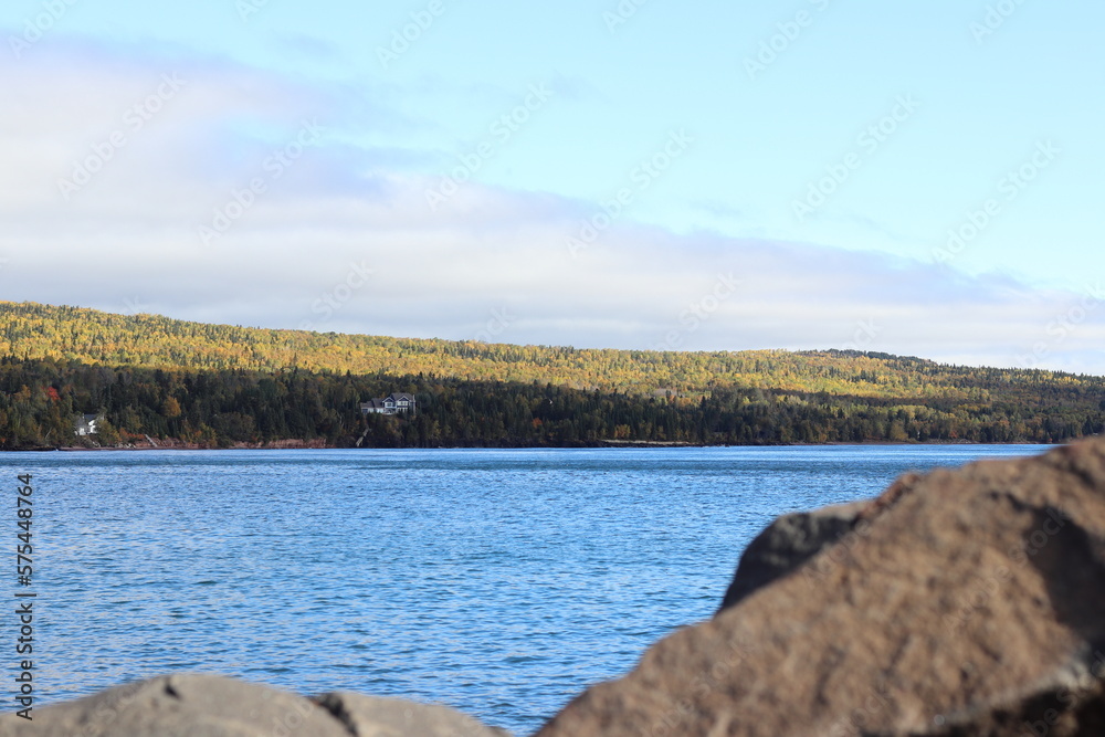 View of Lake Superior rocks and beach with autumn trees in Grand Marais, in Northern Minnesota View of Lake Superior rocks and beach with autumn trees in Grand Marais, in Northern Minnesota