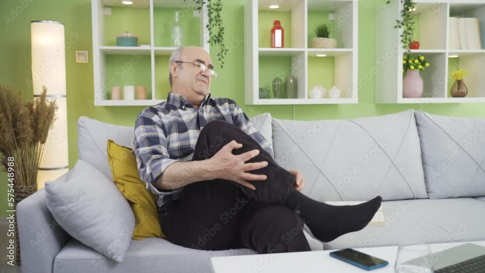 Old sick man with athlete's foot or Allergy is scratching his feet. Old