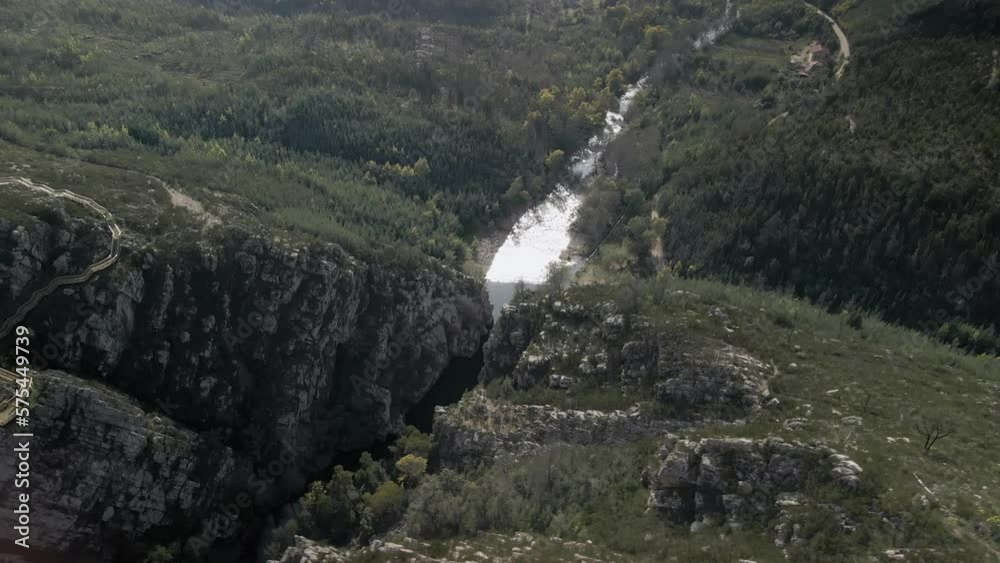 Drone view of the river Ceira getting out of Candosa canyon. River passing in between the rocky mountains at Cabril do Ceira. Drone view of the river Ceira getting out of Candosa canyon. River passing in between the rocky mountains at Cabril do Ceira.