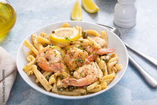 Shrimp piccata pasta in a white bowl photo