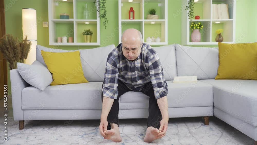 The old man stroking his feet tastes pain and burning sensation. Fungal