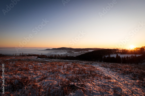 sunset over a foggy valley