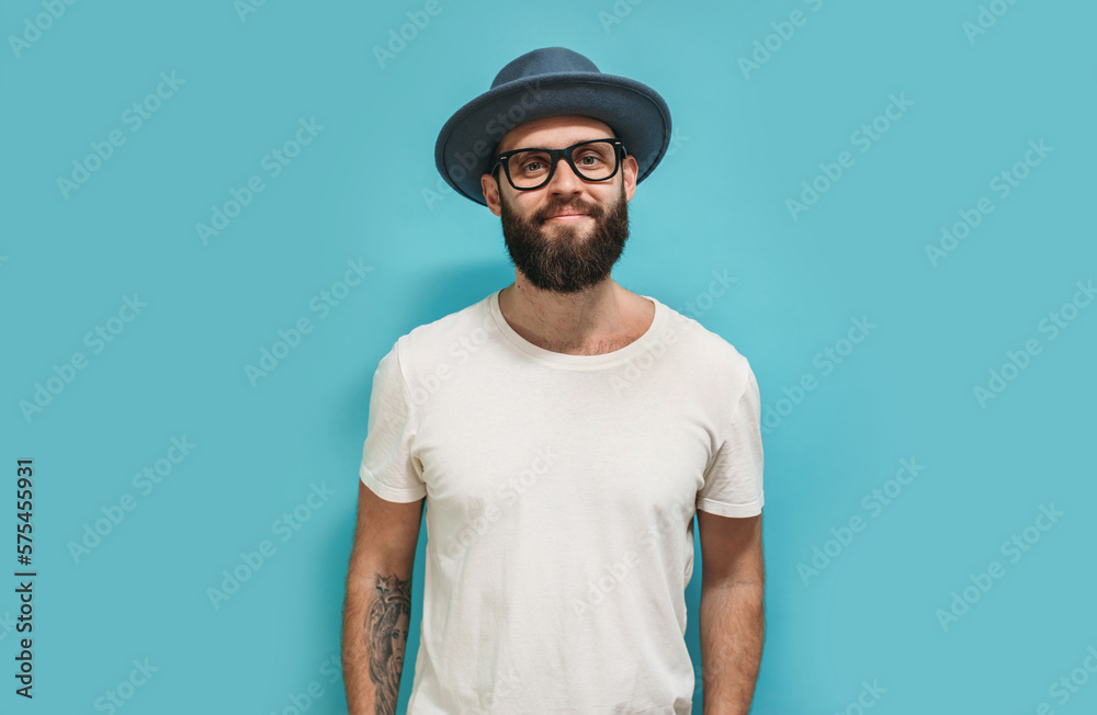 Young bearded hipster guy wearing white blank t shirt with copy space for your text or logo. Mockup for design Young bearded hipster guy wearing white blank t shirt with copy space for your text or logo. Mockup for design
