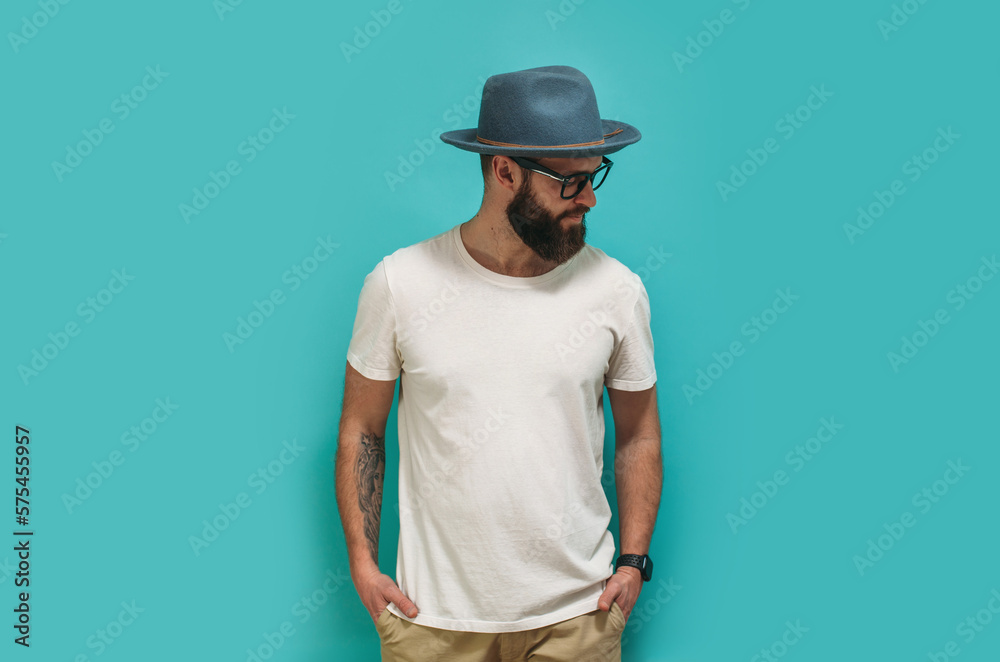 Young bearded hipster guy wearing white blank t shirt with copy space for your text or logo. Mockup for design Young bearded hipster guy wearing white blank t shirt with copy space for your text or logo. Mockup for design