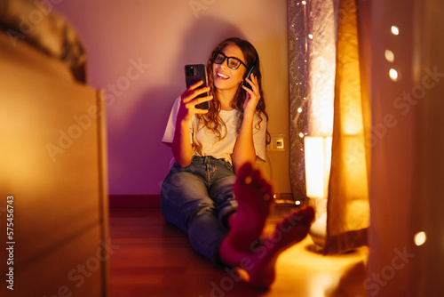 Young woman in headphones listening music and chatting. Lifestyle, relax, technology concept.