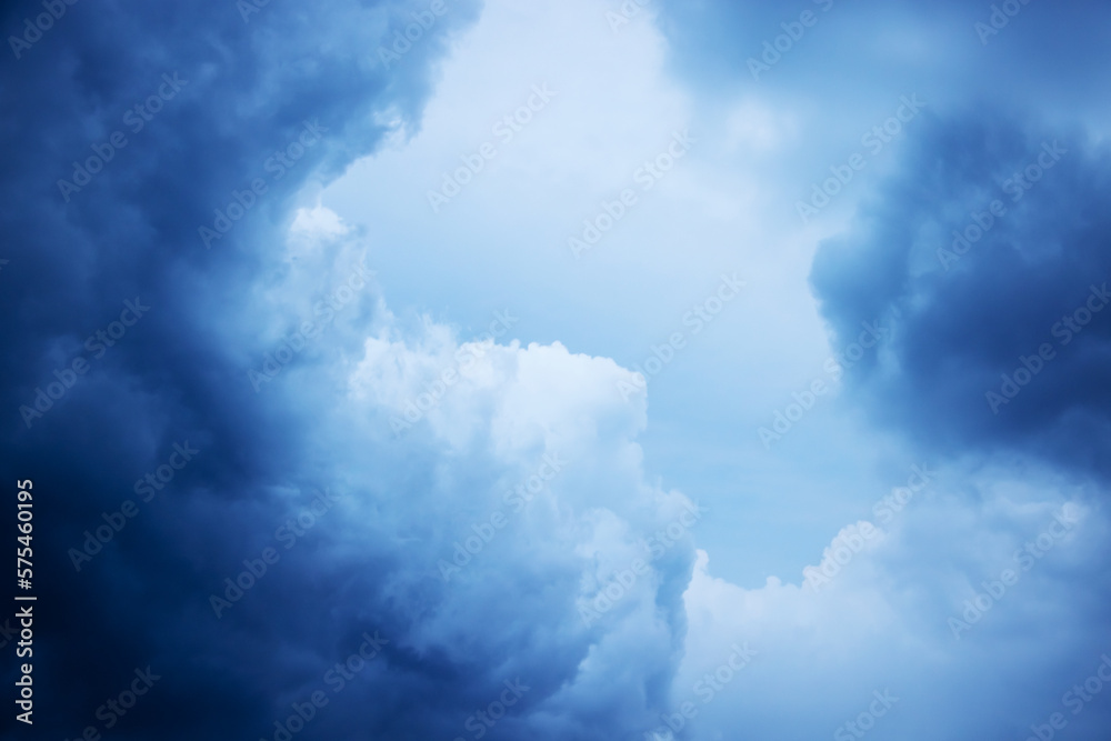 Light in the dark and dramatic storm clouds. Stormy clouds in the dark sky.