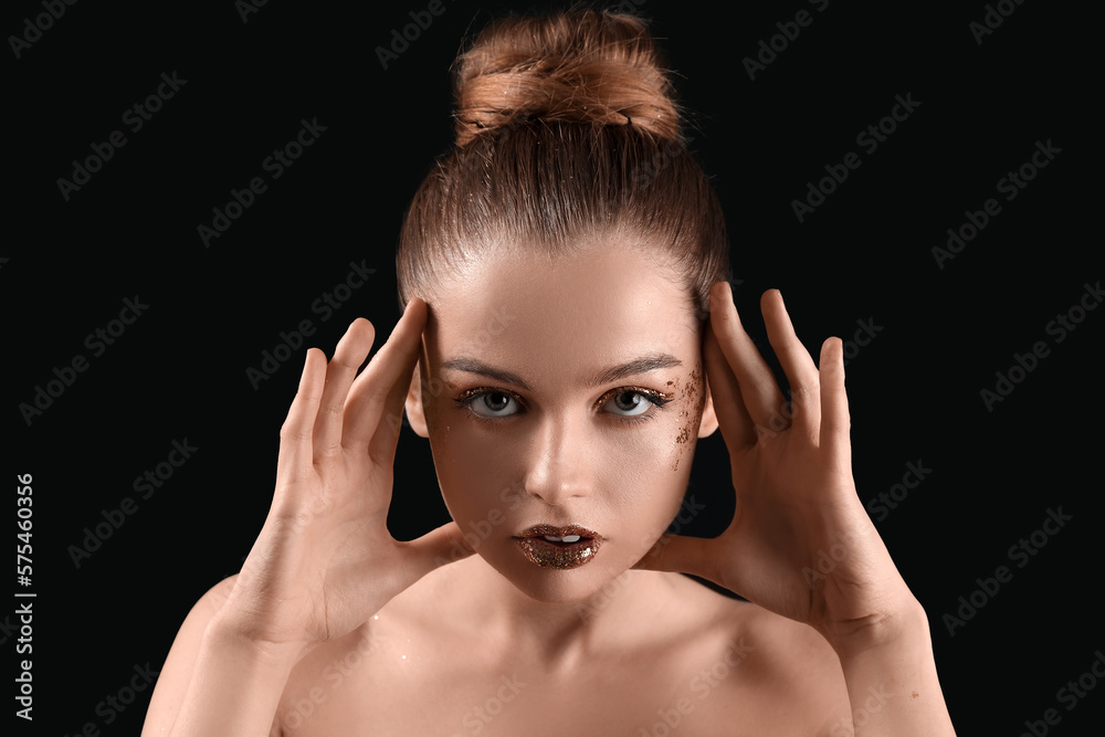 Young woman with golden glitter makeup on black background, closeup Young woman with golden glitter makeup on black background, closeup