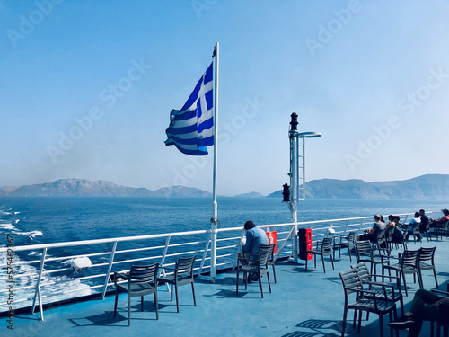 Stern view on a Summer's Day aboard a ferry boat sailing the Dodecanese in Greece flying the Greek flag