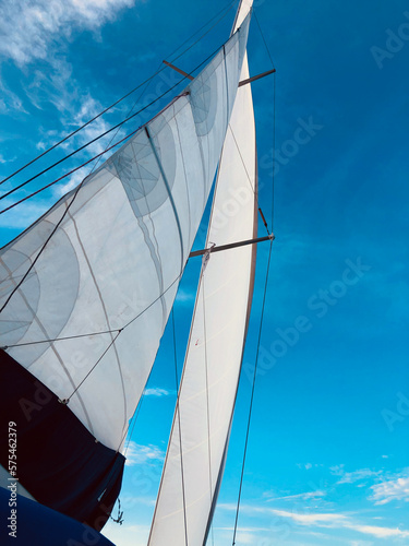 Sailing under full sails in Greek blue waters and skies