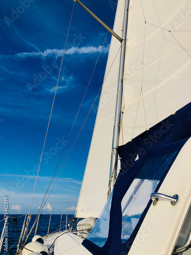 Sailing under full sails in Greek blue waters and skies