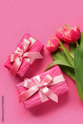 Gift boxes and beautiful tulip flowers on pink background. Hello spring © Pixel-Shot