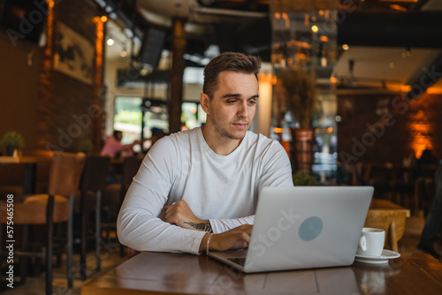 one man work on laptop computer at cafe with bad news worried