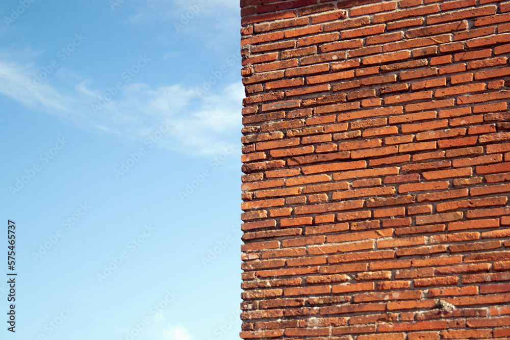 Wall of red brick and blue sky. Wall of red brick and blue sky.