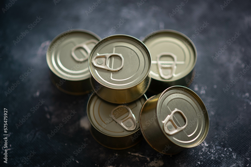 set of canned food on a dark background set of canned food on a dark background