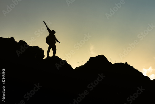Hiker with arms up standing on the top of the mountain - Successful man enjoying triumph - Sport and success concept  © kieferpix