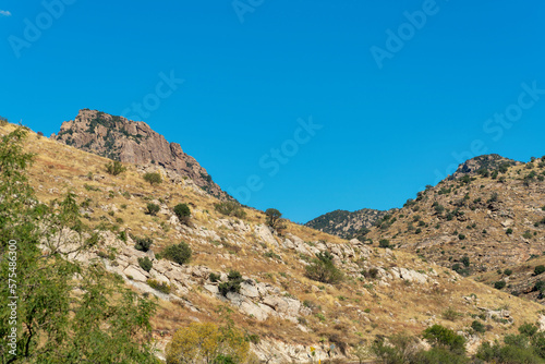Mountainous cliffs in wild western hills of outdoor arizona sonora desert in bright sunny afternoon light with blue sky