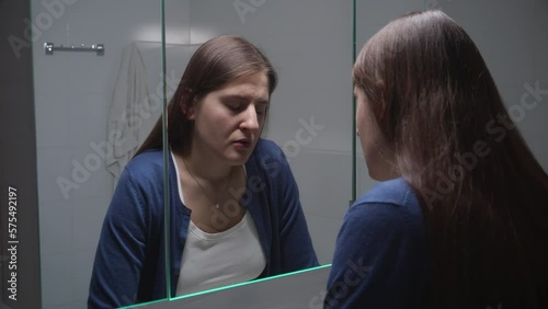 Upset woman standing at sink and thinking of her problems and depression. Concept of depression, stress, mental illness and problems, loneliness and frustration