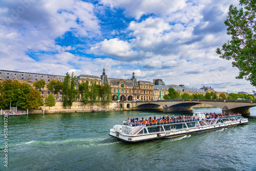 Beautiful scenery of Paris with ferry boat near Pont du Carrousel bridge. France