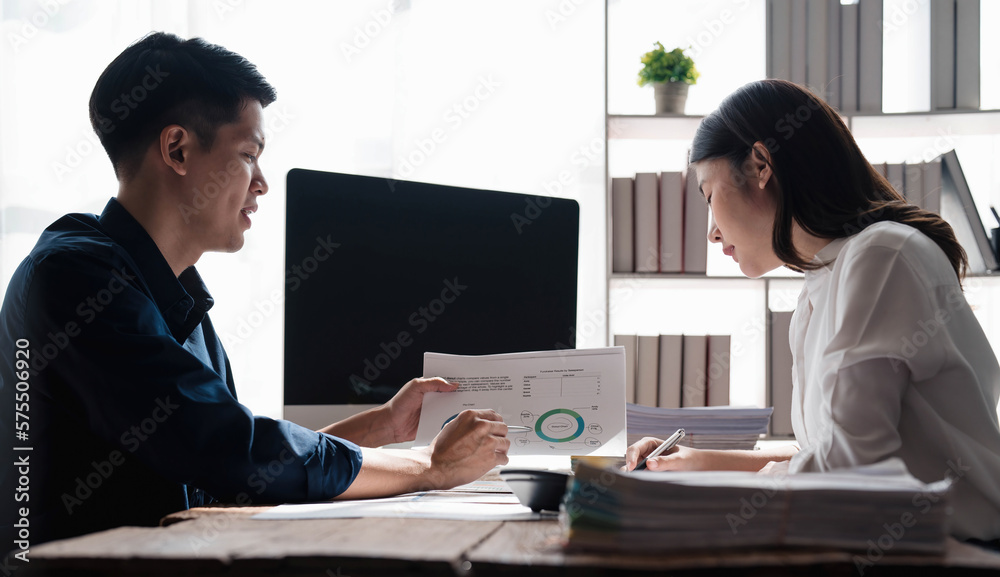 Businesswoman holding pens and holding graph paper are meeting to plan sales to meet targets set in next year... Businesswoman holding pens and holding graph paper are meeting to plan sales to meet targets set in next year...