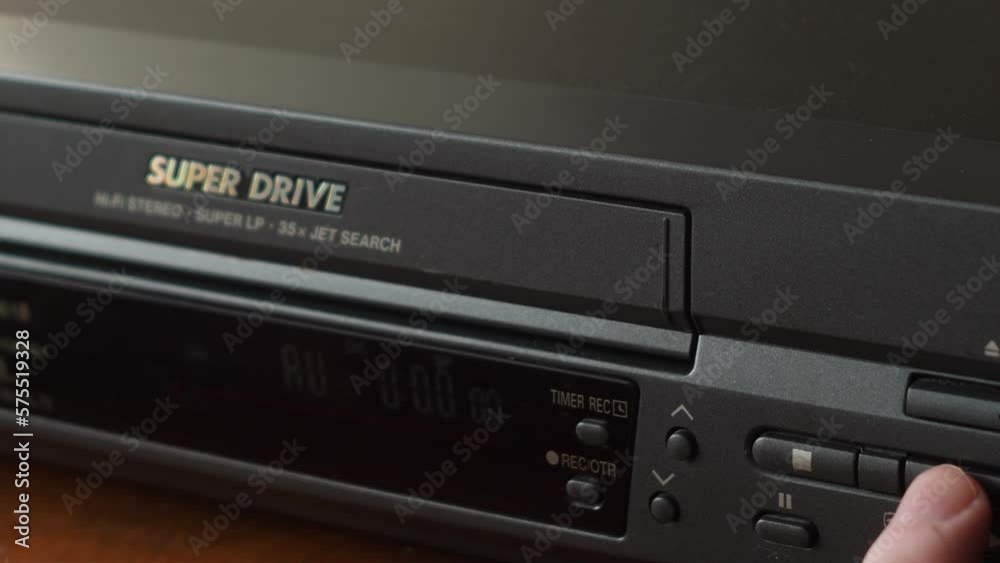 close-up of a video cassette with the inscription wedding is loaded into a vintage video player. selective focus. archival home family filming.wedding video