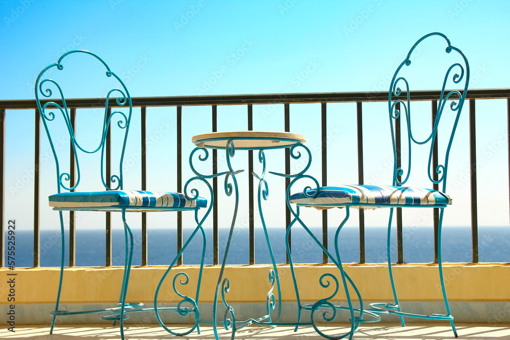 Beautifully stylish table chairs on the sea shore background Beautifully stylish table chairs on the sea shore background