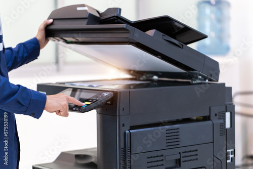 Businessman press button on panel of printer photocopier  network , Working on photocopies in the office concept , printer is office worker tool equipment for scanning and copy paper.