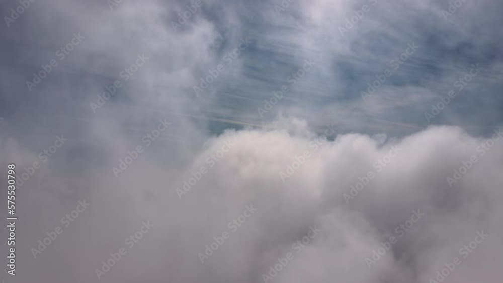 Aerial reveal shot from above at high altitude of dense puffy cumulus clouds flying. Amazing landscape from airplane window point of view Aerial reveal shot from above at high altitude of dense puffy cumulus clouds flying. Amazing landscape from airplane window point of view