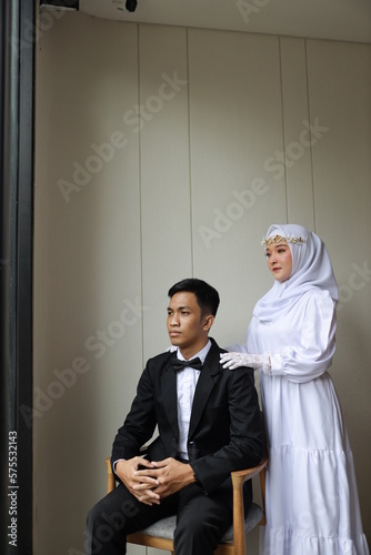 romantic prewedding photo couple of asian man and asian girls wearing neat suits black suits and white dresses indoor concept