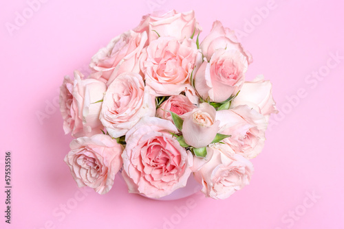 Delicate blooming pink flowers, blooming roses festive pink background, pastel bouquet with floral card, selective focus
