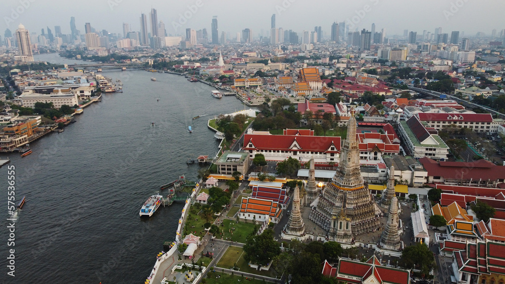 Aerial view of Wat Arun Buddhist temple located on the bank of Chao Phraya river in Bangkok, Thailand.