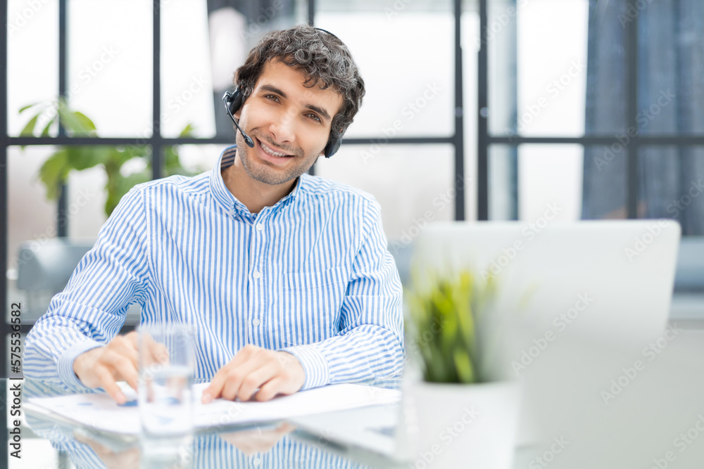 Smiling friendly handsome young male call centre operator. Smiling friendly handsome young male call centre operator.