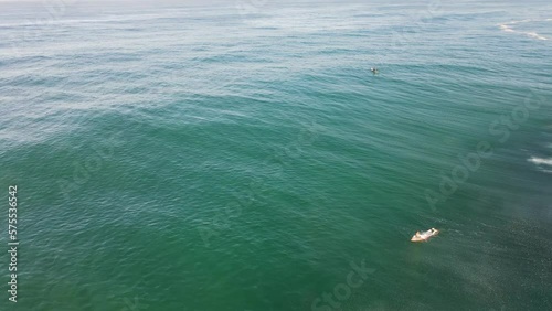 surfer paddling in the blue ocean sunny day waiting for wave lacanau biarritz anglet Basque Country gironde France surf spot summertime surfing good feeling salty view from drone above aerial top