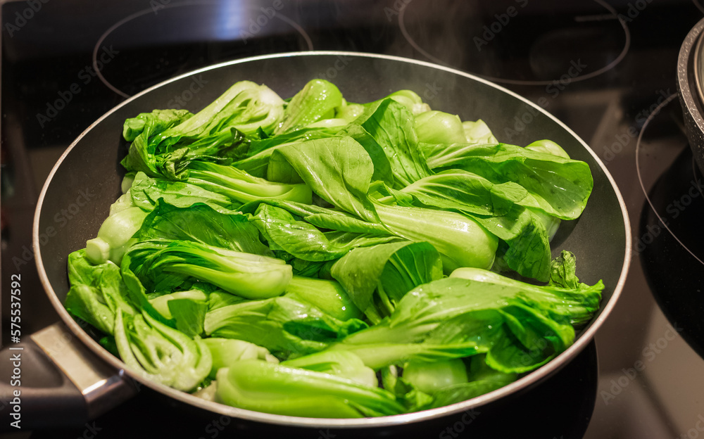 Bok choy stir fry on pan. Stir fried vegetables in a chinese wok