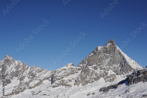 Matterhorn mountain peak in Alps in winter with snow and clear blue sky in Cervinia, Italy and Zermatt, Switzerland. Beautiful and magnificent landscape on a sunny day in Europe
