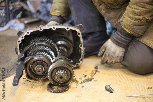 Fototapeta Naklejka Na Ścianę i Meble -  repair of car gearbox mechanisms in a car service in the garage.