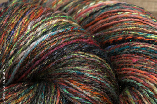 Closeup detail of colourful organic natural handspun and handdyed merino sheep wool yarn , spun on a traditional spinning wheel photo