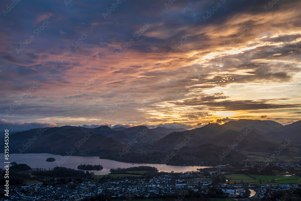 Absolutely wonderful landscape image of view across Derwentwater from Latrigg Fell in lake District during Winter beautiful colorful sunset