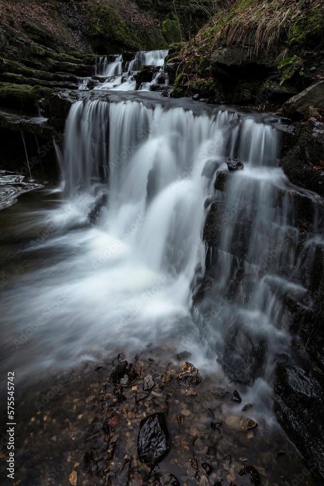 Fototapeta premium Beautiful claming landscape image of Scaleber Force waterfall in Yorkshire Dales in England during Winter morning
