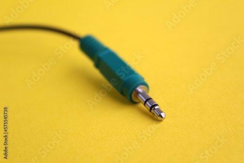 The connector for gadgets lies on a yellow background.