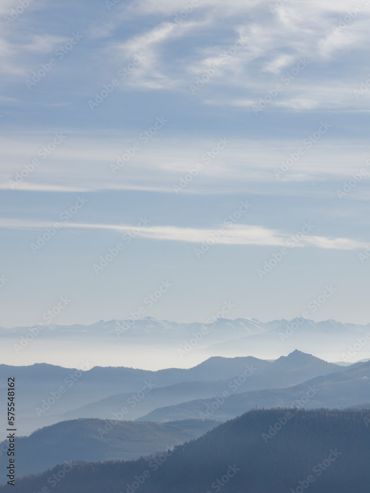 Elevated view across mountain ranges and clouds, winter Elevated view across mountain ranges and clouds, winter