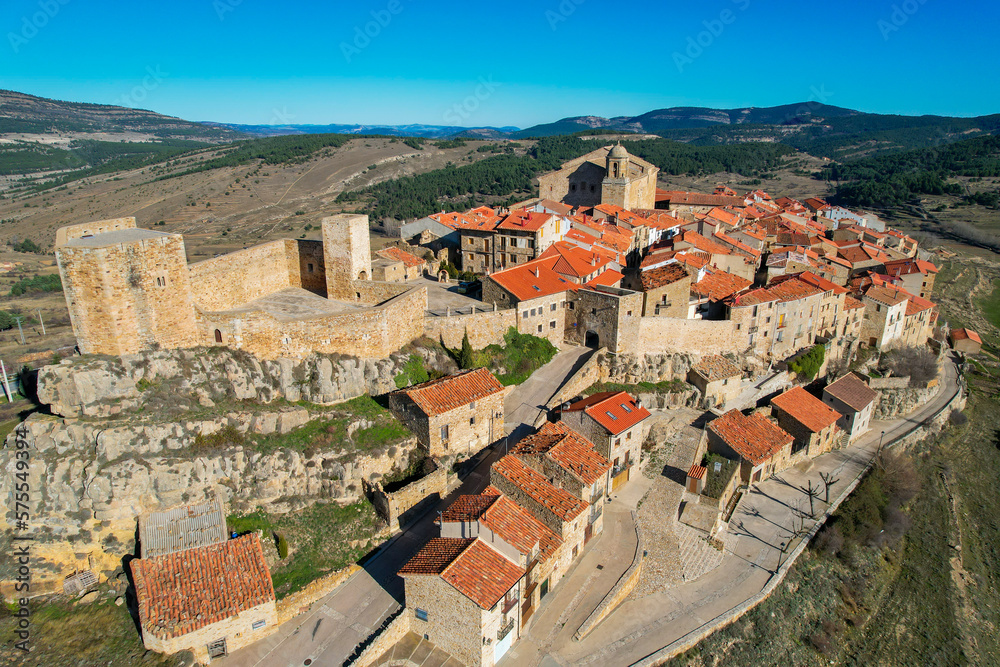 Aerial fly over above the beautiful village of Puertomingalvo in the mountains of Aragon in Teruel Province Spain