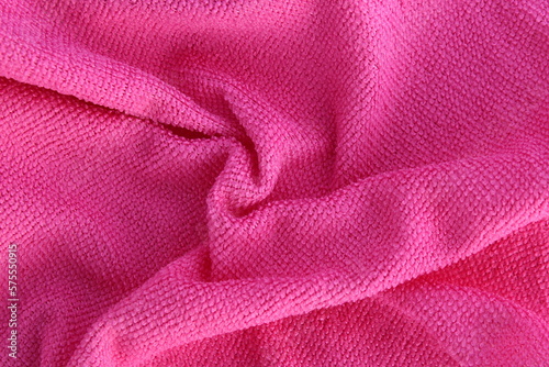 A pink cleaning rag lies on a white isolated background. Texture.