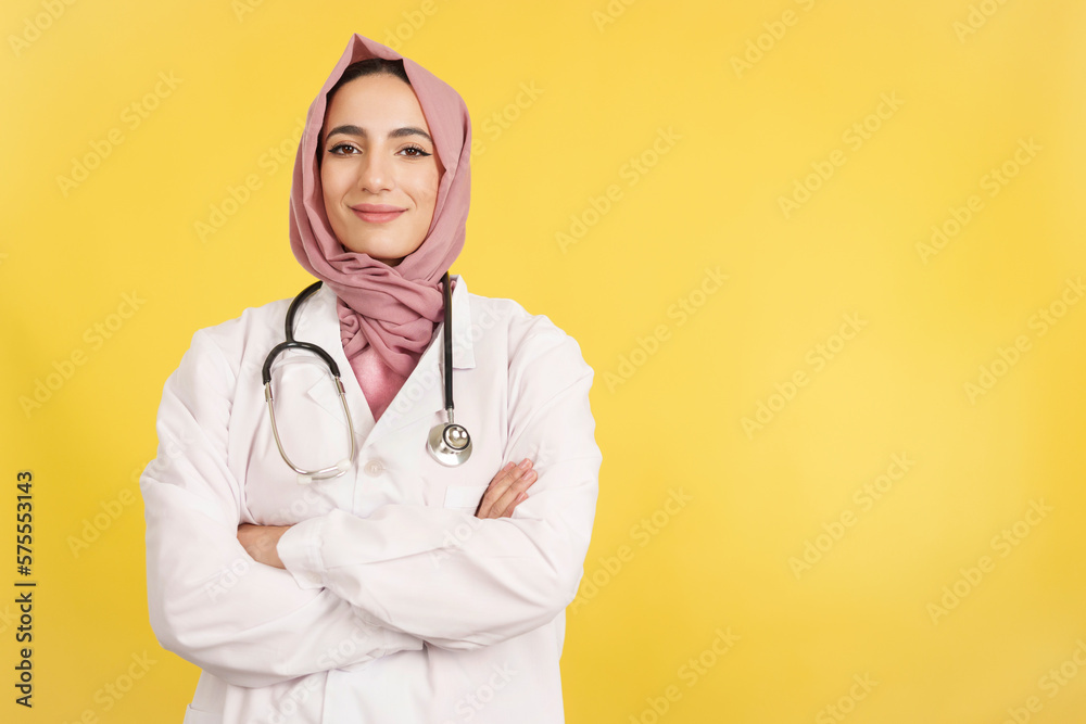Happy female muslim doctor with arms crossed looking at camera