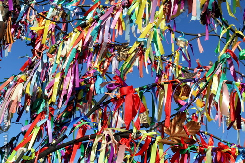 Colorful ribbons hung for good luck on a makeshift iron tree.