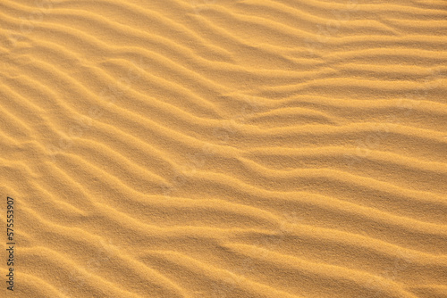 Texture, Waves of sand dune . Background texture of clean yellow sand on windy desert or beach. © ArieStudio