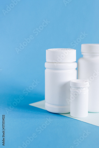 Set of different white bottle mockup on blue background, pill bottles without label design, copy space 